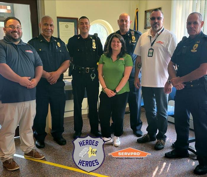 group of police officers and SERVPRO employees together