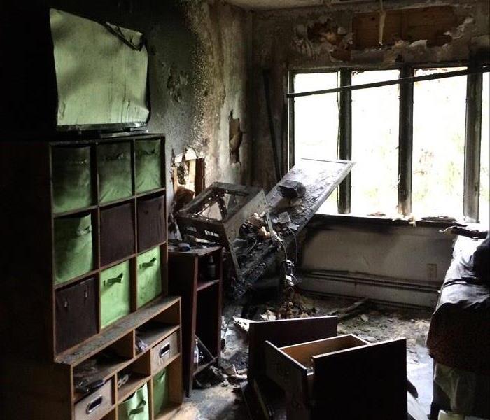 Fire damaged bookshelves and miscellaneous furniture