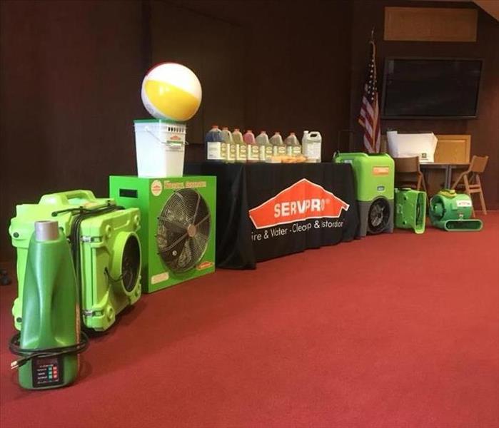SERVPRO equipment lined up along the front of a continuing education classroom