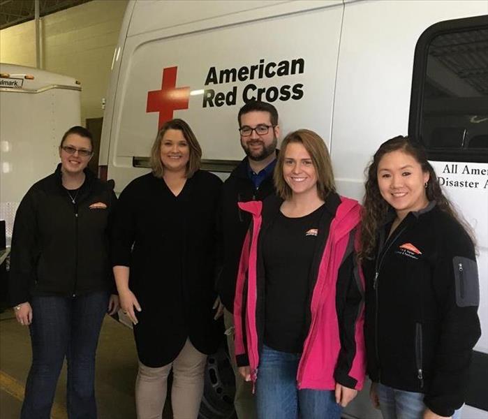 SERVPRO Sales Team posed in front of an American Red Cross cargo van