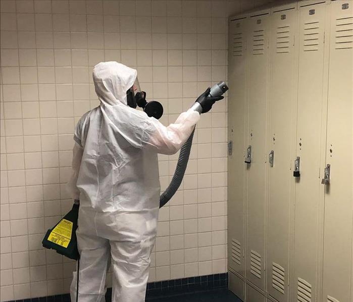 Team member fogging during a commercial disinfection.