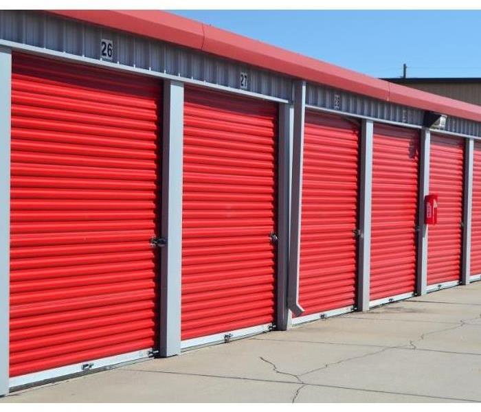 A row of 5 red storage container bay doors