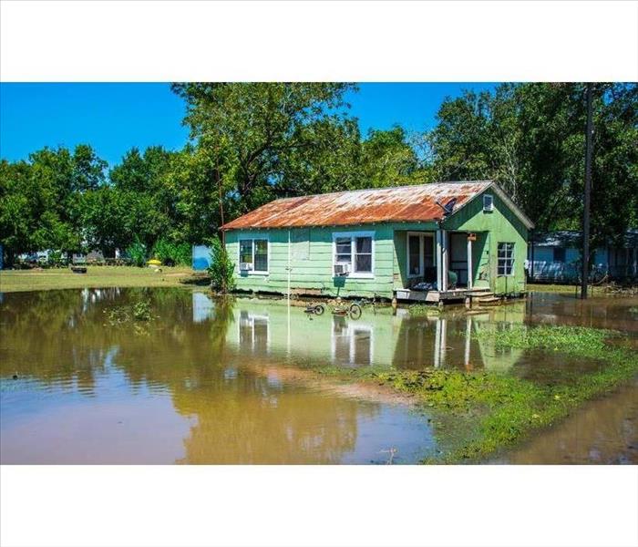 Destroyed home after flood reflected in water