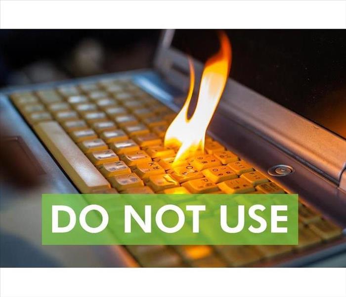 Computer keyboard with fire flame and the words DO NOT USE